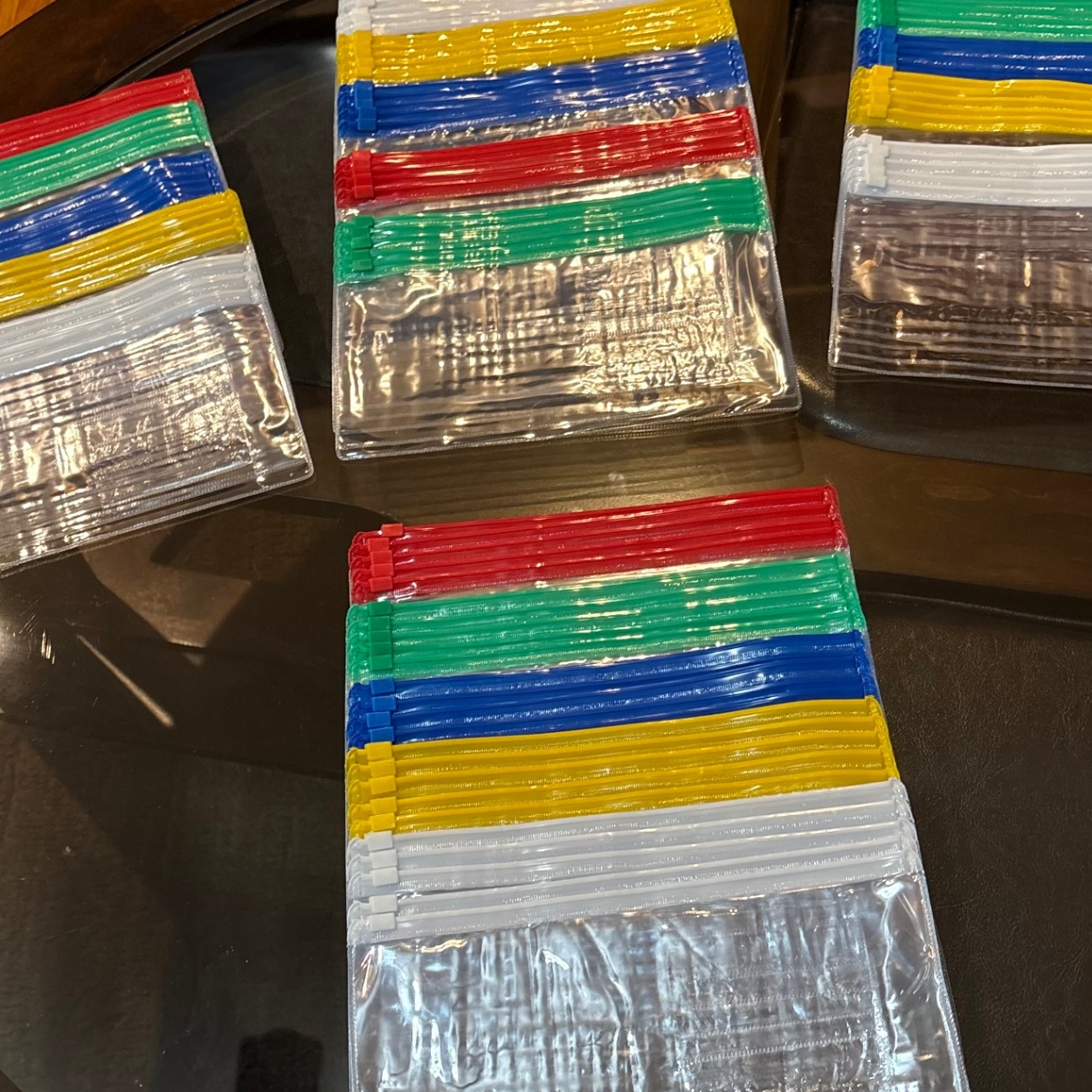 Color-coded plastic zip savings envelopes sorted in stacks